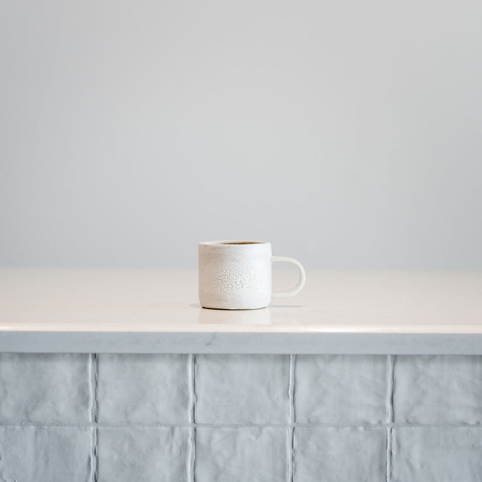 Small textured white ceramic mug