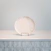 The plate is finished in a matte blush glaze and has a soft, speckle to its surface.